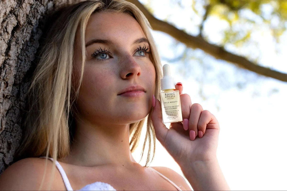 girl holding nourishing eye cream in her hand